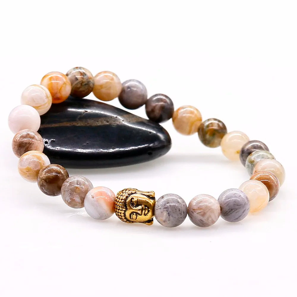 Vue rapprochée pièce centrale tête de Bouddha dorée sur bracelet en agate naturelle