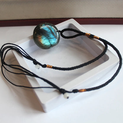 Détail reflets labradorescence bleu nuit sur pendentif labradorite rond